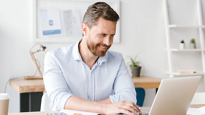 Mann arbeitet am Laptop